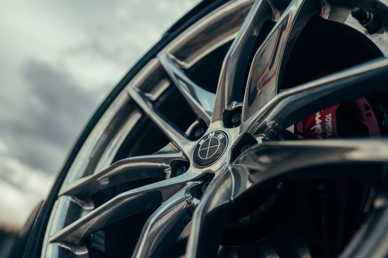 Detailed image of a car alloy wheel, showcasing modern design with sharp lines and sleek appearance.